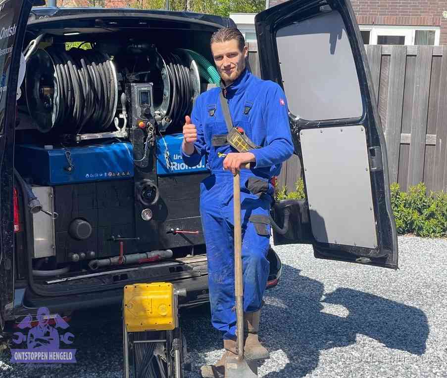 Monteur met duim omhoog bij de rioolreinigingsbus, duidelijke kosten voor riool ontstoppen in Hengelo